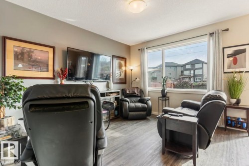 Spacious room featuring wood-finish flooring, a large window, and light-toned walls - 12737 205 Street Nw, Edmonton, AB - Indoor
