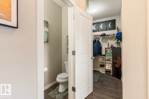Powder room with a toilet, featuring wood-finish flooring - 12737 205 Street Nw, Edmonton, AB - Indoor