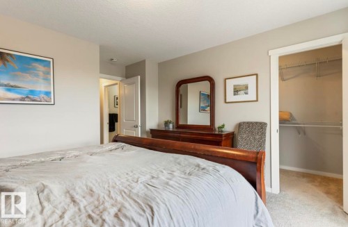 Neutral wall color, wall-to-wall carpeting, white trim, open closet with wire shelving, interior doorway - 12737 205 Street Nw, Edmonton, AB - Indoor Photo Showing Bedroom