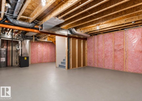 Expansive unfinished basement featuring an exposed joist ceiling, insulated walls, and concrete flooring - 12737 205 Street Nw, Edmonton, AB - Indoor Photo Showing Basement