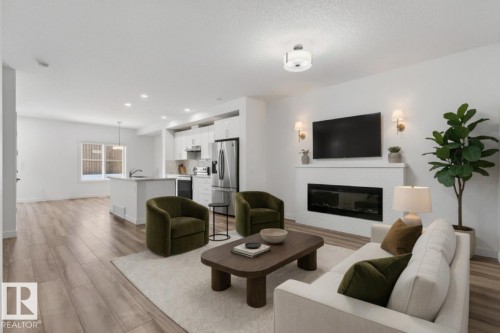 Photo has been virtually staged - 4853 Alwood Point(E) Sw, Edmonton, AB - Indoor Photo Showing Living Room With Fireplace