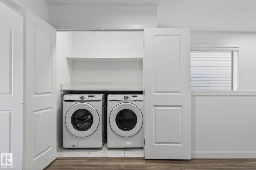 Laundry closet with bifold doors, integrated shelving, and a tile floor - 4853 Alwood Point(E) Sw, Edmonton, AB - Indoor Photo Showing Laundry Room