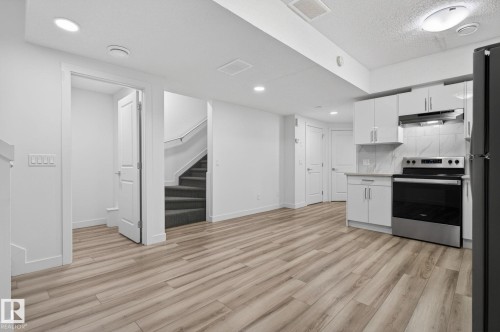 Modern kitchen with stainless steel appliances, white cabinetry, and a subway tile backsplash - 4853 Alwood Point(E) Sw, Edmonton, AB - Indoor Photo Showing Kitchen