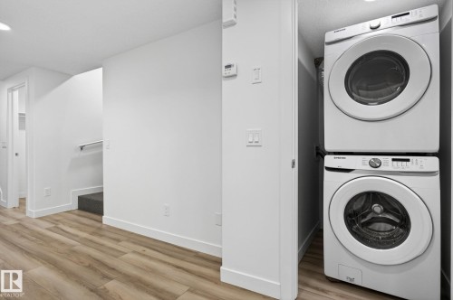Wood-finish flooring, white walls, and a recessed ceiling light - 4853 Alwood Point(E) Sw, Edmonton, AB - Indoor Photo Showing Laundry Room