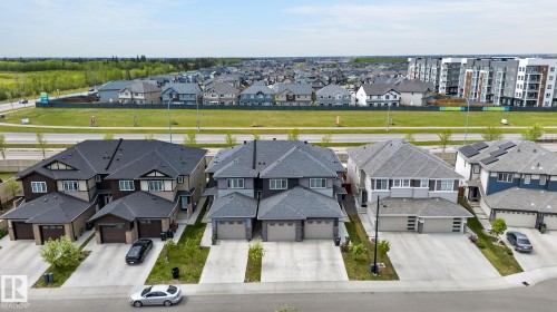 Newly constructed neighborhood featuring contemporary townhomes, attached garages, and paved driveways - 4853 Alwood Point(E) Sw, Edmonton, AB - Outdoor With Facade
