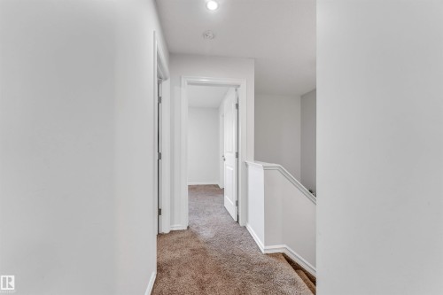 Carpeted hallway featuring white walls and recessed lighting - 2040 24 Street Nw, Edmonton, AB - Indoor Photo Showing Other Room