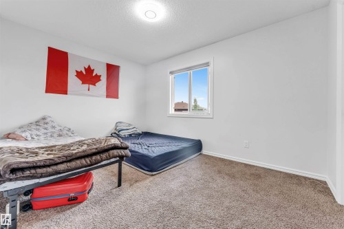 Recessed lighting, neutral wall paint, and window with exterior scenery - 2040 24 Street Nw, Edmonton, AB - Indoor Photo Showing Bedroom