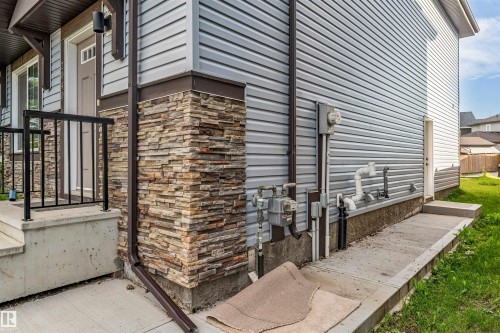 Exterior siding in a light gray finish with stone veneer accents - 2040 24 Street Nw, Edmonton, AB - Outdoor
