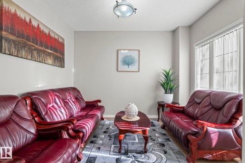 Neutral wall finishes, recessed lighting, and a large window with vertical blinds - 3403 23 Nw, Edmonton, AB - Indoor Photo Showing Living Room