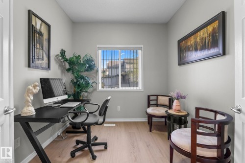 Light-toned wood-finish flooring, neutral wall paint, and a bright window - 3403 23 Nw, Edmonton, AB - Indoor Photo Showing Office