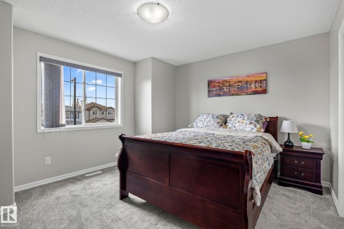 Gray carpeting, light gray wall paint, and a multi-pane window with blinds - 3403 23 Nw, Edmonton, AB - Indoor Photo Showing Bedroom