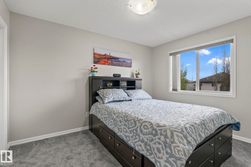 Neutral wall color, wall-to-wall carpeting, and a window with roller blinds - 3403 23 Nw, Edmonton, AB - Indoor Photo Showing Bedroom