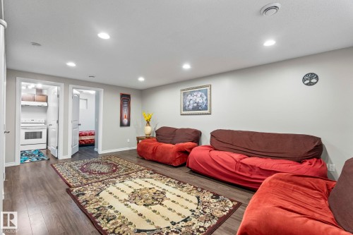 Spacious interior with wood-finish flooring, recessed lighting, and light gray wall paint - 3403 23 Nw, Edmonton, AB - Indoor Photo Showing Basement