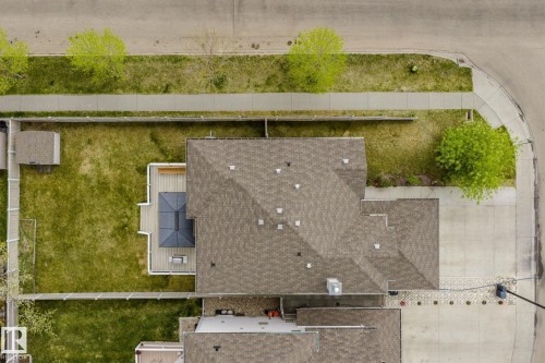 Expansive backyard featuring a manicured lawn, a detached storage shed, and a composite deck with a gazebo - 3403 23 Nw, Edmonton, AB - Outdoor