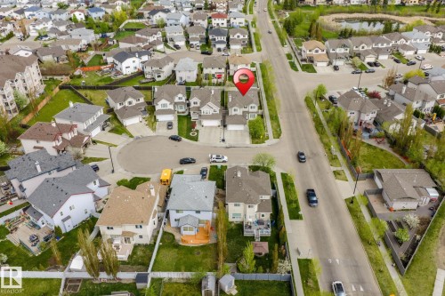 Residential neighborhood with varied architectural styles, green spaces, and paved roads - 3403 23 Nw, Edmonton, AB - Outdoor With View