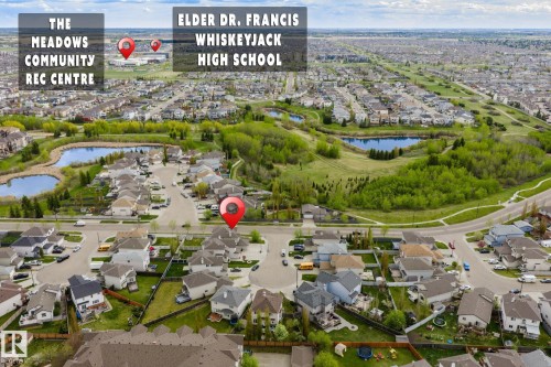 Aerial view of a residential neighborhood with houses, streets, and green spaces, including multiple ponds - 3403 23 Nw, Edmonton, AB - Outdoor With View