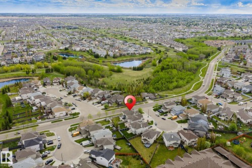 Aerial perspective of a residential neighborhood with established homes, mature landscaping, and multiple water features - 3403 23 Nw, Edmonton, AB - Outdoor With View