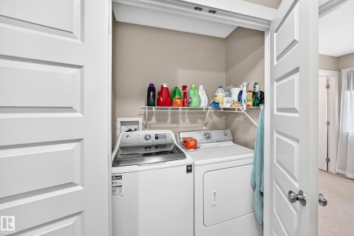 Laundry closet featuring bi-fold panel doors, upper wire shelving, and neutral wall paint - 466 Chappelle Drive Sw, Edmonton, AB - Indoor Photo Showing Laundry Room