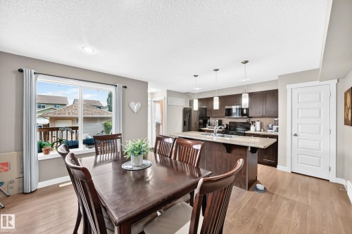 Open concept dining area with wood-finish flooring - 466 Chappelle Drive Sw, Edmonton, AB - Indoor Photo Showing Dining Room