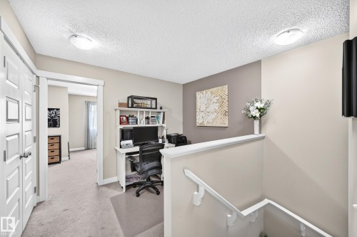 Upper-level landing featuring a built-in desk with shelving, neutral wall tones, and recessed lighting - 466 Chappelle Drive Sw, Edmonton, AB - Indoor