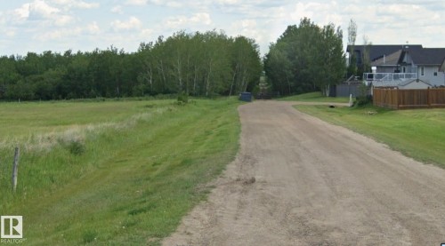 Road through the treeline to access the 2 acreage parcels - 45 St 58 Ave, Tofield, AB 