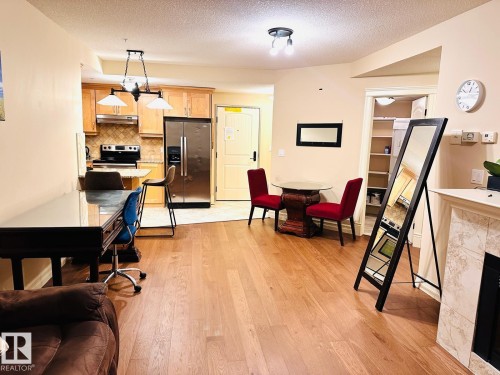 Hardwood-style flooring throughout living areas - #207 10142 111 St Nw, Edmonton, AB - Indoor