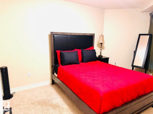 Carpeted flooring, neutral wall color, and a window with vertical blinds - #207 10142 111 St Nw, Edmonton, AB - Indoor Photo Showing Bedroom
