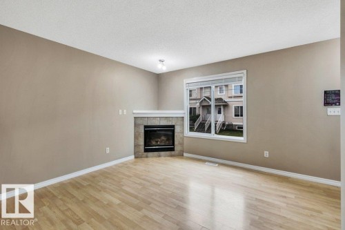 #33 2503 24 St Nw, Edmonton, AB - Indoor Photo Showing Living Room With Fireplace