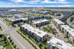 Aerial perspective showcasing multi-story residential buildings, surface parking areas, and surrounding roadways - 