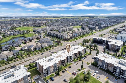 Modern multi-story building featuring multiple balconies and surface parking - #409 11804 22 Av Sw, Edmonton, AB - Outdoor With View