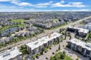 Modern multi-story building featuring multiple balconies and surface parking - #409 11804 22 Av Sw, Edmonton, AB  - Outdoor With View 