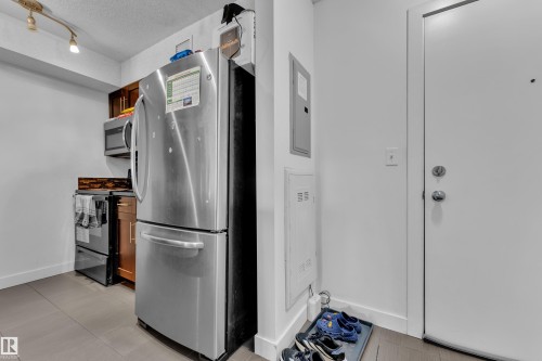 Stainless steel refrigerator, stainless steel microwave, and built-in oven range - #409 11804 22 Av Sw, Edmonton, AB - Indoor