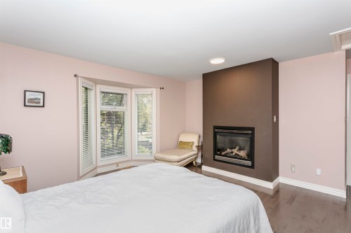15104 42 Avenue Nw, Edmonton, AB - Indoor Photo Showing Bedroom With Fireplace