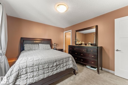 Carpeted bedroom with neutral wall tones and a white ceiling - 34 Stirling Road Nw, Edmonton, AB - Indoor Photo Showing Bedroom
