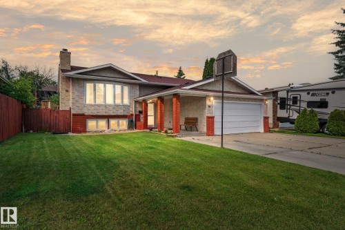 Split-level residence featuring a brick and stone facade, a two-car garage, and a covered front entry - 34 Stirling Road Nw, Edmonton, AB - Outdoor