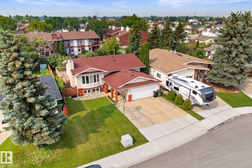 Single-family residence featuring a red shingle roof, bay window, and a two-car garage - 34 Stirling Road Nw, Edmonton, AB - Outdoor