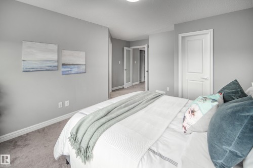 Neutral wall color, carpeted flooring, white trim, and white paneled doors - 16015 11 Avenue Sw, Edmonton, AB - Indoor Photo Showing Bedroom