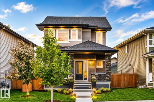Contemporary two-story exterior with a gabled roof, stone accents, and a covered entry - 16015 11 Avenue Sw, Edmonton, AB - Outdoor