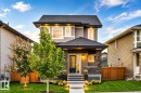 Contemporary two-story exterior with a gabled roof, stone accents, and a covered entry - 16015 11 Avenue Sw, Edmonton, AB  - Outdoor 