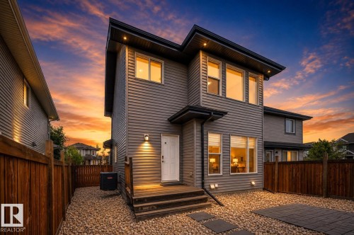 Modern architectural design with gray horizontal siding, dark trim, and multiple large windows - 16015 11 Avenue Sw, Edmonton, AB - Outdoor With Exterior
