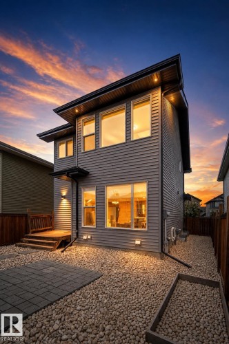 Modern siding exterior with multiple large windows - 16015 11 Avenue Sw, Edmonton, AB - Outdoor With Exterior