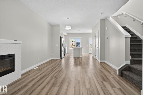 Electric fireplace with geometric tile surround - 4879 Alwood Point(E) Sw, Edmonton, AB - Indoor With Fireplace