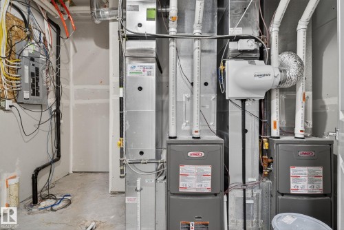Dual Lennox HVAC units, whole-home humidifier, and a dedicated electrical panel - 4879 Alwood Point(E) Sw, Edmonton, AB - Indoor Photo Showing Basement