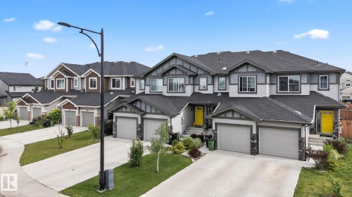 Contemporary multi-story facade featuring mixed siding, prominent gables, and multiple two-car garages - 4879 Alwood Point(E) Sw, Edmonton, AB - Outdoor With Facade