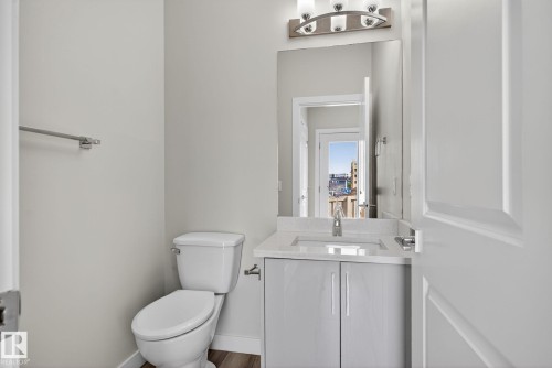 Modern vanity with an integrated sink, polished chrome faucet, and under-cabinet storage - 4879 Alwood Point(E) Sw, Edmonton, AB - Indoor Photo Showing Bathroom