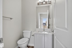 Modern vanity with an integrated sink, polished chrome faucet, and under-cabinet storage - 