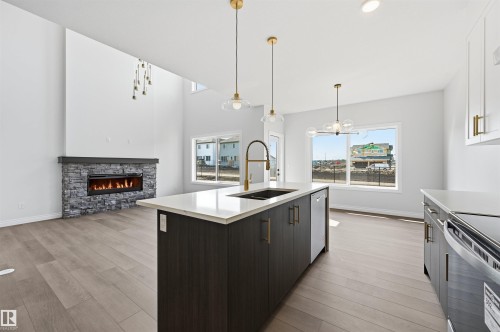 935 18 Avenue Nw, Edmonton, AB - Indoor Photo Showing Kitchen With Fireplace With Double Sink With Upgraded Kitchen