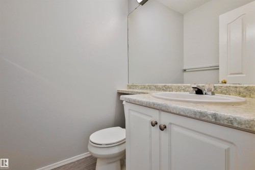 Vanity with white cabinetry, integrated sink, and laminate countertop - 15529 95 Avenue Nw, Edmonton, AB - Indoor Photo Showing Bathroom