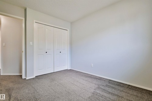Neutral wall color complemented by gray carpeting - 15529 95 Avenue Nw, Edmonton, AB - Indoor Photo Showing Other Room