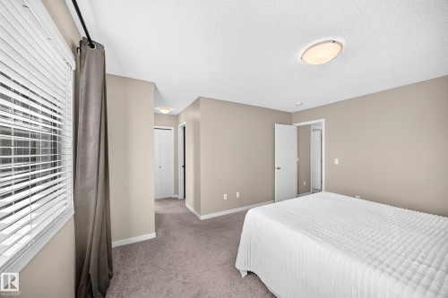 Neutral-toned walls complement plush carpeting - 5147 Crabapple Link Sw, Edmonton, AB - Indoor Photo Showing Bedroom